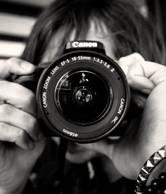 A photographer raising a camera to their eye