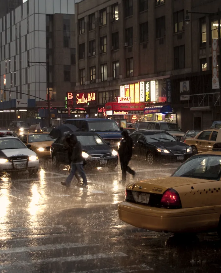 Wet reflections and a cab on a rainy street