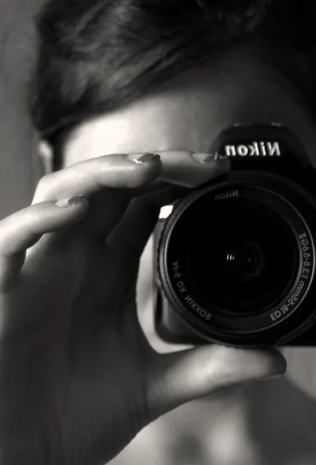 A photographer with a camera raised to their eye