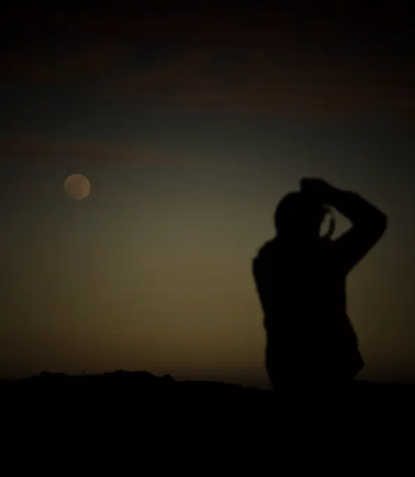 A figure silhouetted against the last light of the sky