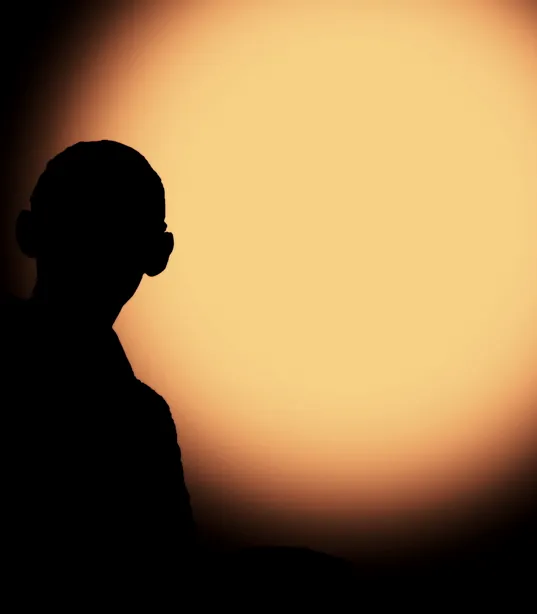 A figure silhouetted against a low sun