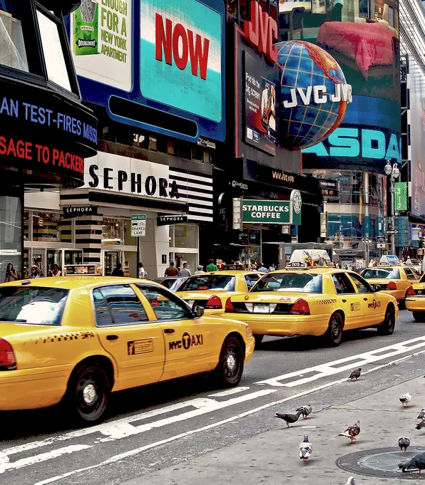 Taxis waiting at a lit crossing