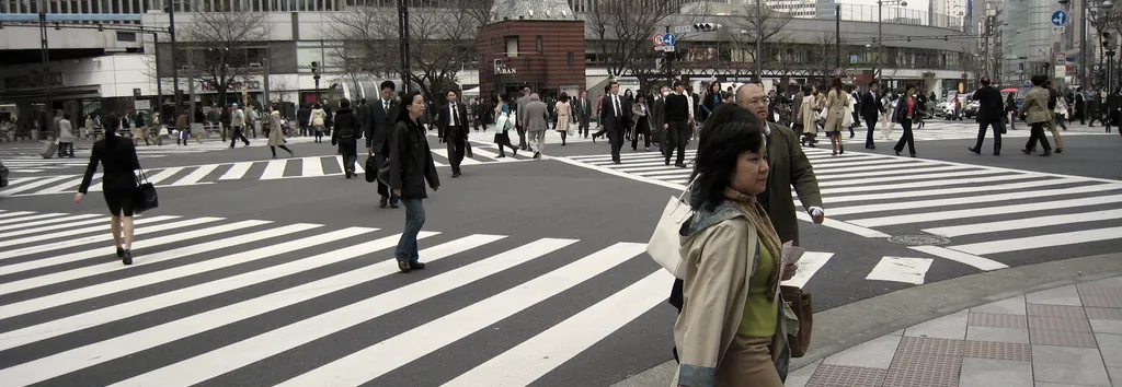 A wide crossing filled with pedestrians, a frame from film work